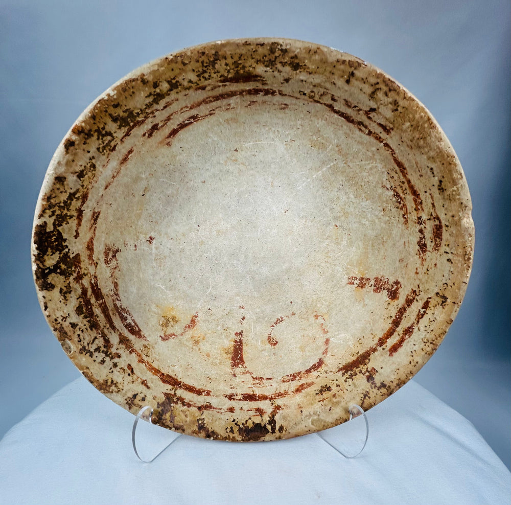 Ancient Pre-Columbian ceramic bowl showing concentric painted bands and natural earthen patina from burial.