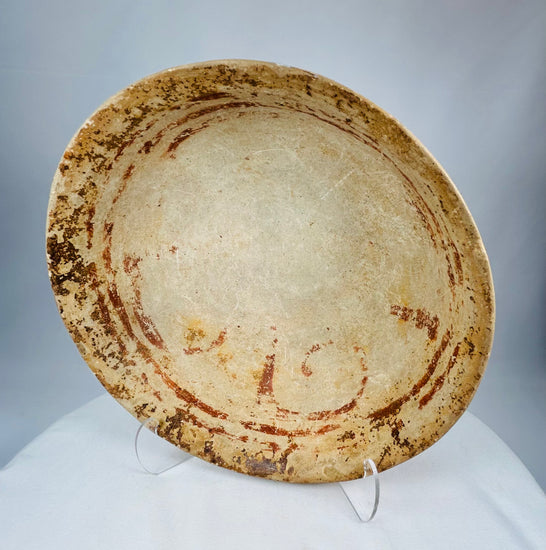Hand-formed Pre-Columbian terracotta bowl with broad interior surface and traces of red pigment.