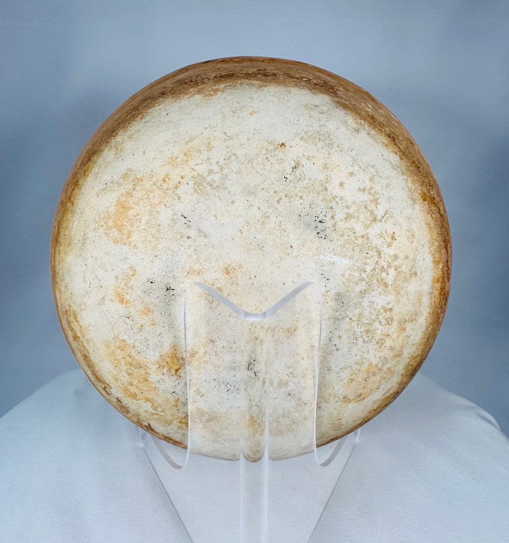 Ancient Mesoamerican terracotta bowl displaying firing variations and centuries-old burial patina.