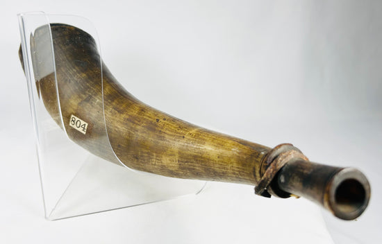 Colonial or European powder horn crafted from animal horn, used for musket and flintlock powder storage.