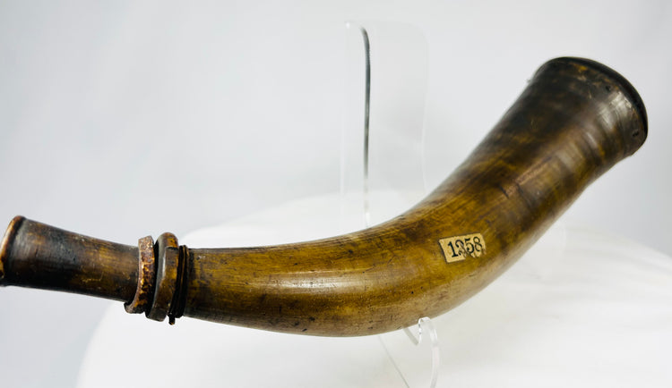 18th century black powder horn displaying natural striations, handling wear, and archival labels.