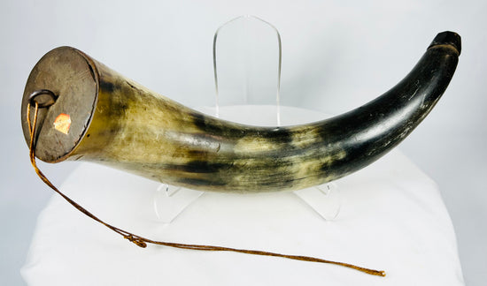 Historic black powder horn crafted from natural animal horn with wooden base plug