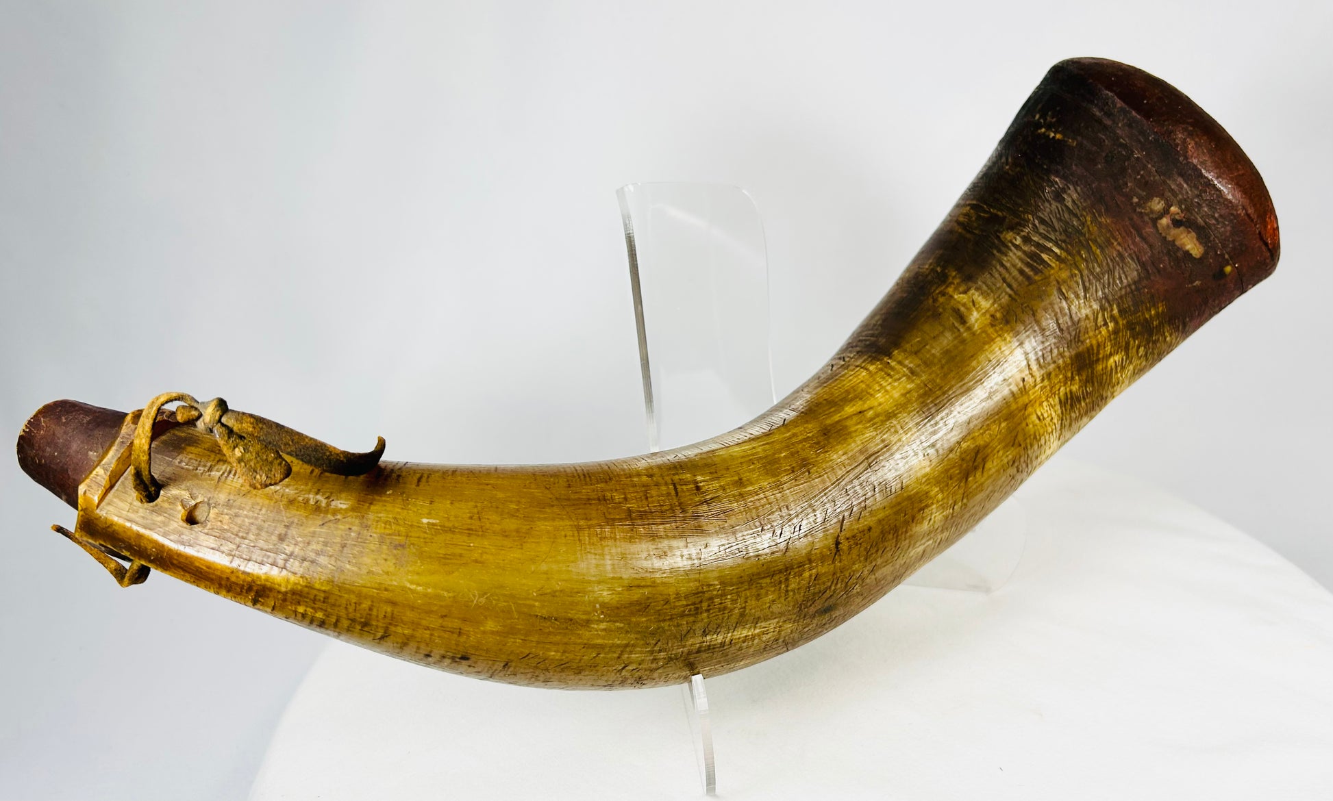 Detail view of leather thong attached to antique powder horn