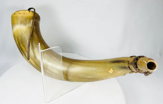 Close view of historic priming powder horn used for flintlock firearms