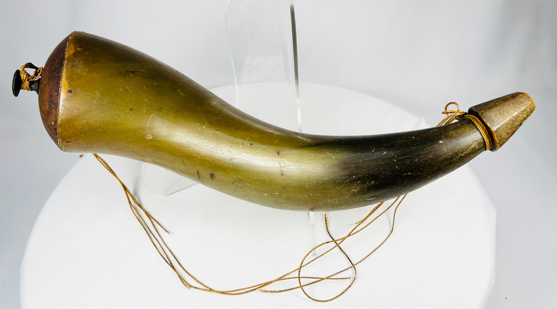 Side view of antique horn powder flask showing natural translucency and wear