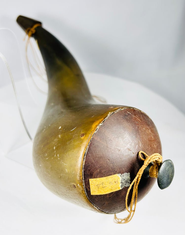 Close-up of wooden stopper and cord on historic horn vessel