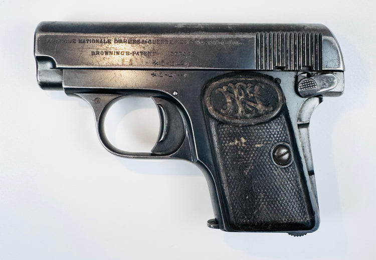 Belgian FN Browning Model 1906 with stamped slide lettering, a curved trigger, and a textured FN-monogram grip.