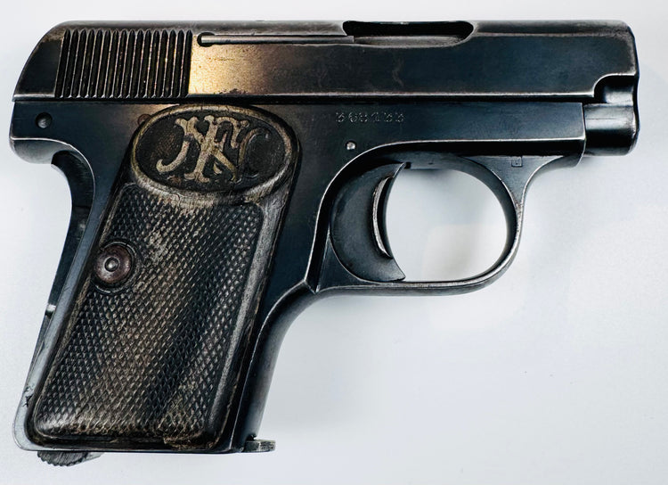 FN Browning Model 1906 highlighting worn grip checkering, an oval FN emblem, and silvered edges on the steel frame.