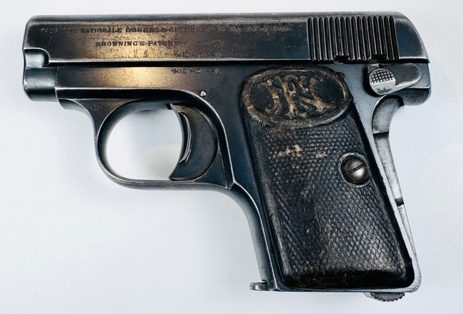 Deactivated Browning Model 1906 displaying slide lettering, deep slide serrations, and an enlarged manual safety lever.