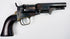 1859 Colt Model 1849 Pocket Revolver displaying mottled cylinder wear, an aged steel frame, and a dark walnut grip.