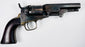 1859 Colt Model 1849 Pocket Revolver displaying mottled cylinder wear, an aged steel frame, and a dark walnut grip.