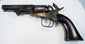 Colt Model 1849 Pocket Revolver with a smooth walnut grip, aged brass backstrap, and dark steel barrel and cylinder.