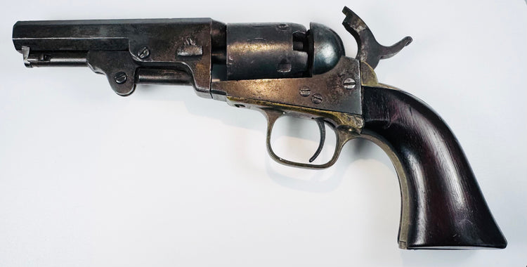 1859 Colt Model 1849 Pocket Revolver displaying its compact frame, five-shot cylinder, curved trigger, and octagonal barrel.