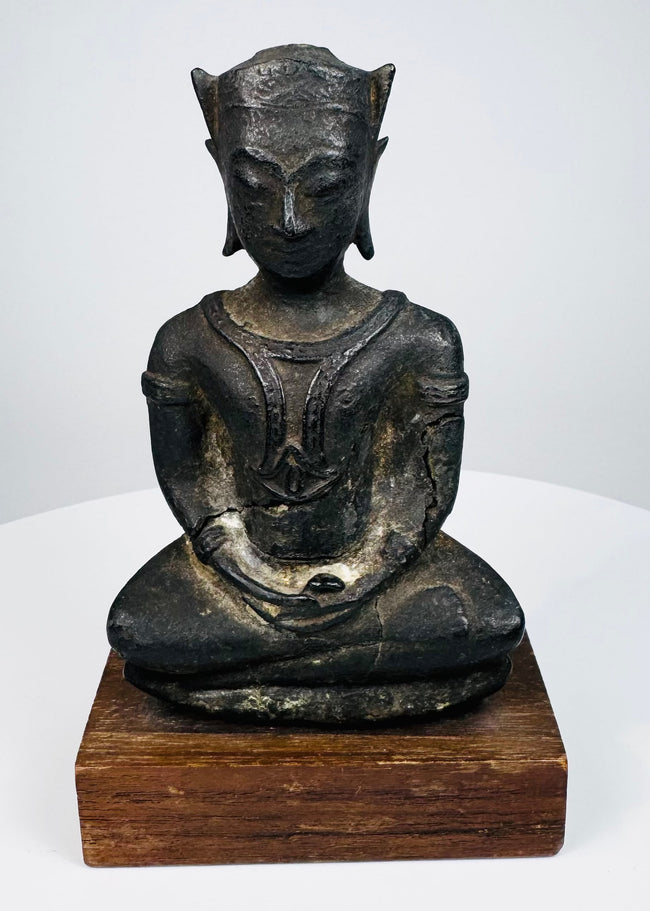 Shan-style bronze Buddha with a structured crown, elongated earlobes, and hands resting together in its lap.