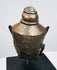 Southeast Asian Buddha head sculpture with serene facial features and textured aged metal