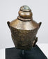 Southeast Asian Buddha head sculpture with serene facial features and textured aged metal