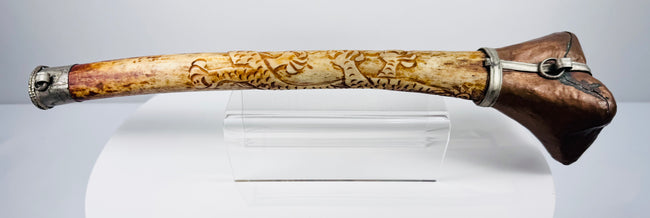 Detailed Tibetan Buddhist kangling showing carved dragon ornamentation, natural bone patina and metal fittings