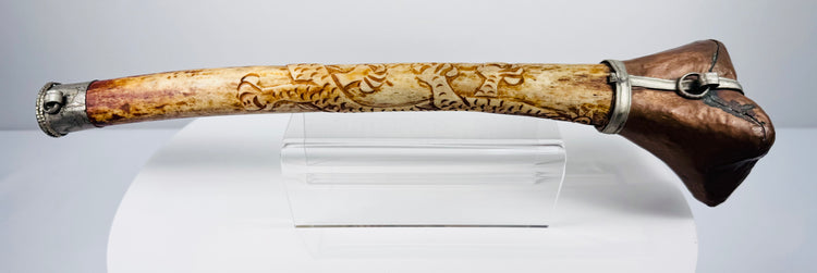 Detailed Tibetan Buddhist kangling showing carved dragon ornamentation, natural bone patina and metal fittings