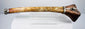 Detailed Tibetan Buddhist kangling showing carved dragon ornamentation, natural bone patina and metal fittings