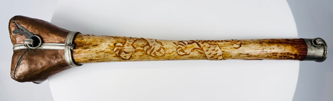 Carved Tibetan kangling human bone ritual instrument featuring detailed dragon motifs and fitted metal terminal