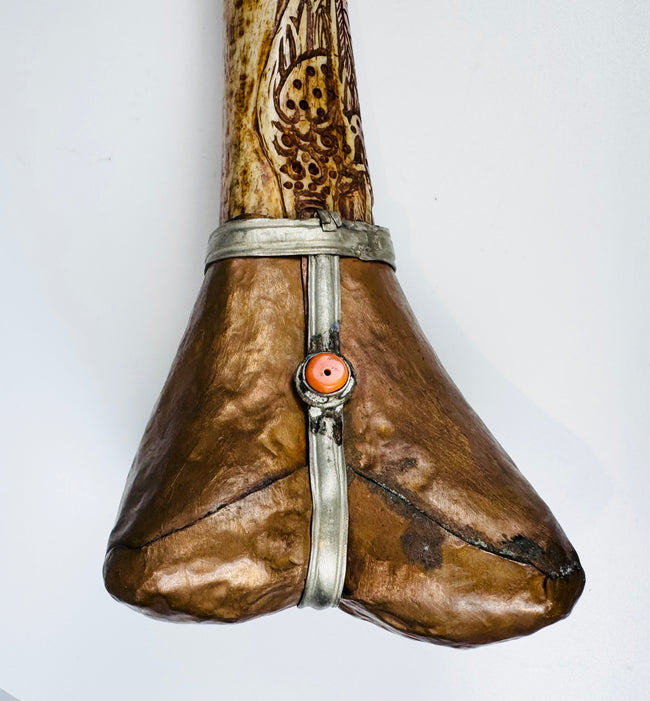 Decorative terminal of antique Tibetan kangling showing fitted metalwork and naturally aged human bone