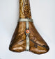 Decorative terminal of antique Tibetan kangling showing fitted metalwork and naturally aged human bone