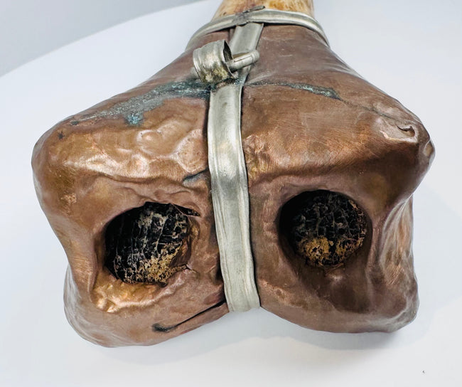 Historic Tibetan Buddhist ritual trumpet displaying intricate carved bone craftsmanship and aged metal mounts