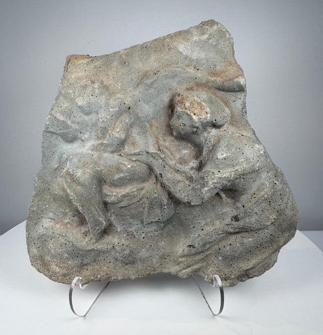 Roman volcanic tuff relief fragment with weathered Classical figures and ancient stone patina