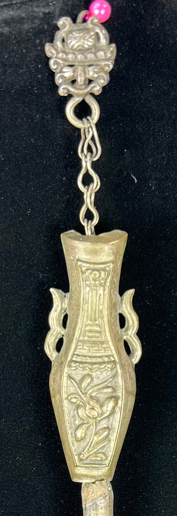Detailed view of Chinese silver vessel-form pendant with auspicious decoration