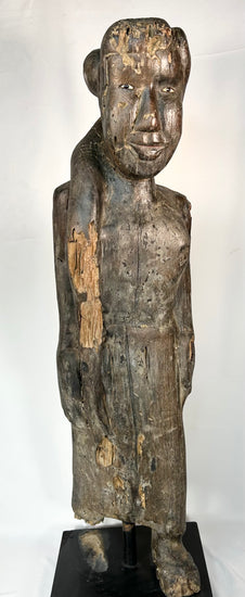 Hand-carved Dayak ancestral figure with inset eyes and aged surface