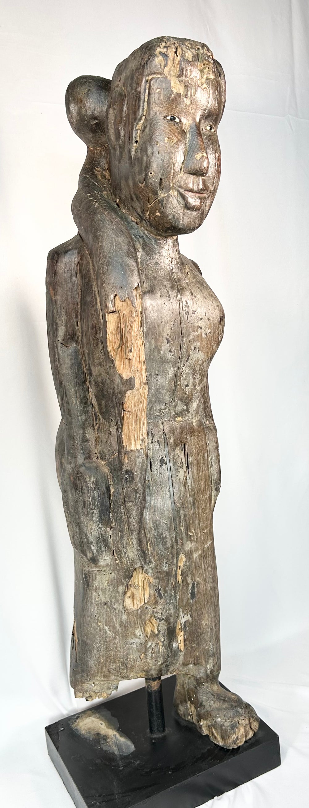 Large antique Borneo wooden ritual figure with elongated proportions