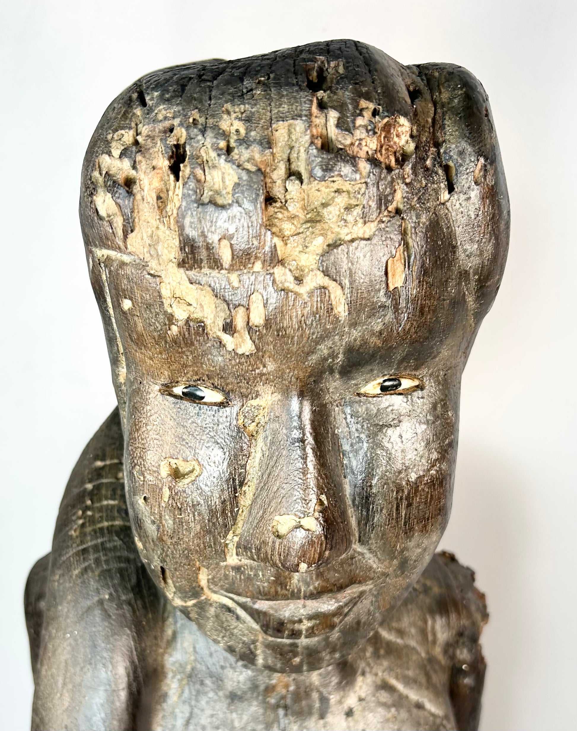 Indonesian Dayak wooden sculpture with inset eyes and ritual wear