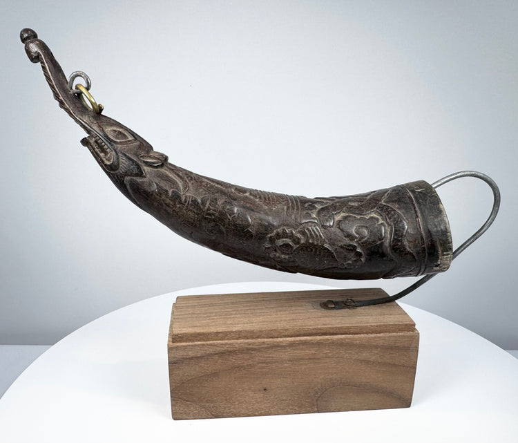Antique Tibetan carved ritual horn from the Himalayan region, 18th–19th century, with elongated curved form and rich aged patina.