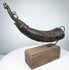 Tibetan Buddhist ritual horn carved from horn, featuring a makara-form tip and decorative carved details along the body.