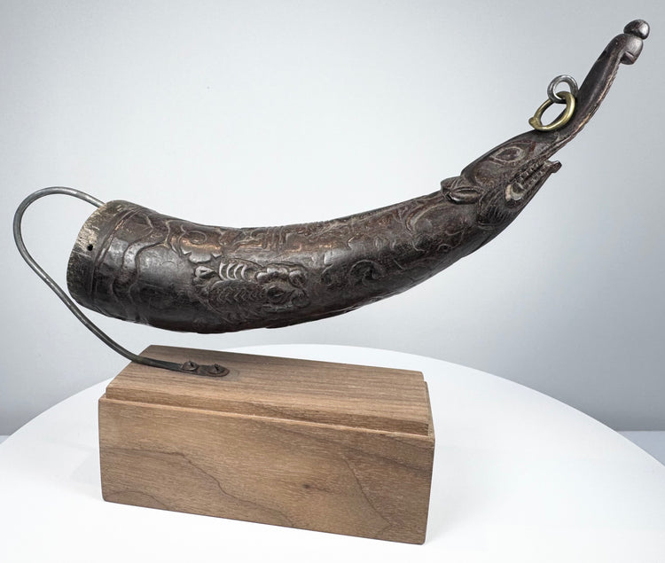 Historic Himalayan ritual horn from Tibet showing intricate surface carving, elongated snout, and ceremonial craftsmanship.