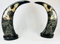 Polished water buffalo horn carvings featuring dragons and prowling tigers amidst clouds, mounted on black lacquered bases