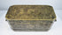Front exterior of an antique Mindanao betel box showing engraved floral decoration, brass inlay, and rectangular form.
