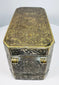 Top of a Philippine betel nut box displaying dense floral scrollwork and symmetrical brass-inlaid decoration across the lid.