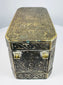 Side of a Mindanao betel nut box with ornate brass-inlaid floral motifs and naturally aged dark metal patina.