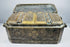 Angled exterior of an antique Southeast Asian betel nut box highlighting its rectangular form, brass borders, and engraved side panels.