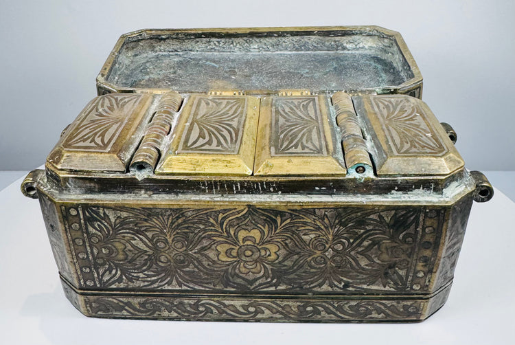 Angled exterior of an antique Southeast Asian betel nut box highlighting its rectangular form, brass borders, and engraved side panels.