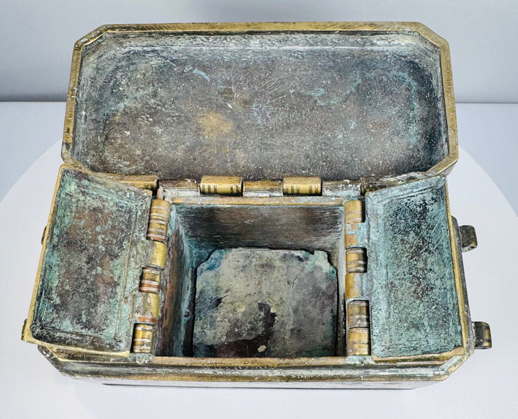 Fully opened Philippine betel nut box displaying its compartmentalized interior, hinged lids, aged patina, and traditional metal construction.