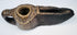 Ancient Islamic stone oil lamp with hand-carved geometric motifs, open wick spout, and naturally aged surface patina.