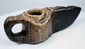 Islamic period stone oil lamp, circa 7th–12th century CE, with weathered patina and preserved incised motifs.