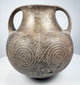 Ancient Etruscan terracotta amphora showing its rounded body, high loop handles, short neck, and dark impasto surface.