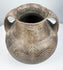 Straight-on photograph of the Etruscan impasto amphora showing both loop handles and symmetrical concentric spiral decoration.