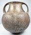 Opposite side of the impasto amphora with one handle prominent and concentric spirals extending across the lower body.