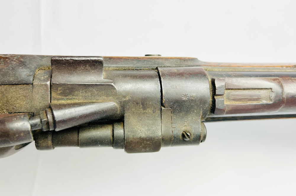 Macro detail of the Snider-Enfield Mk II barrel and hinged breechblock showing proof marks and aged military finish.