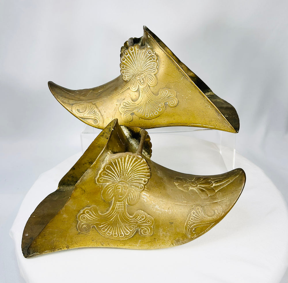 Antique Latin American brass slipper stirrups featuring enclosed riding design and aged patina.