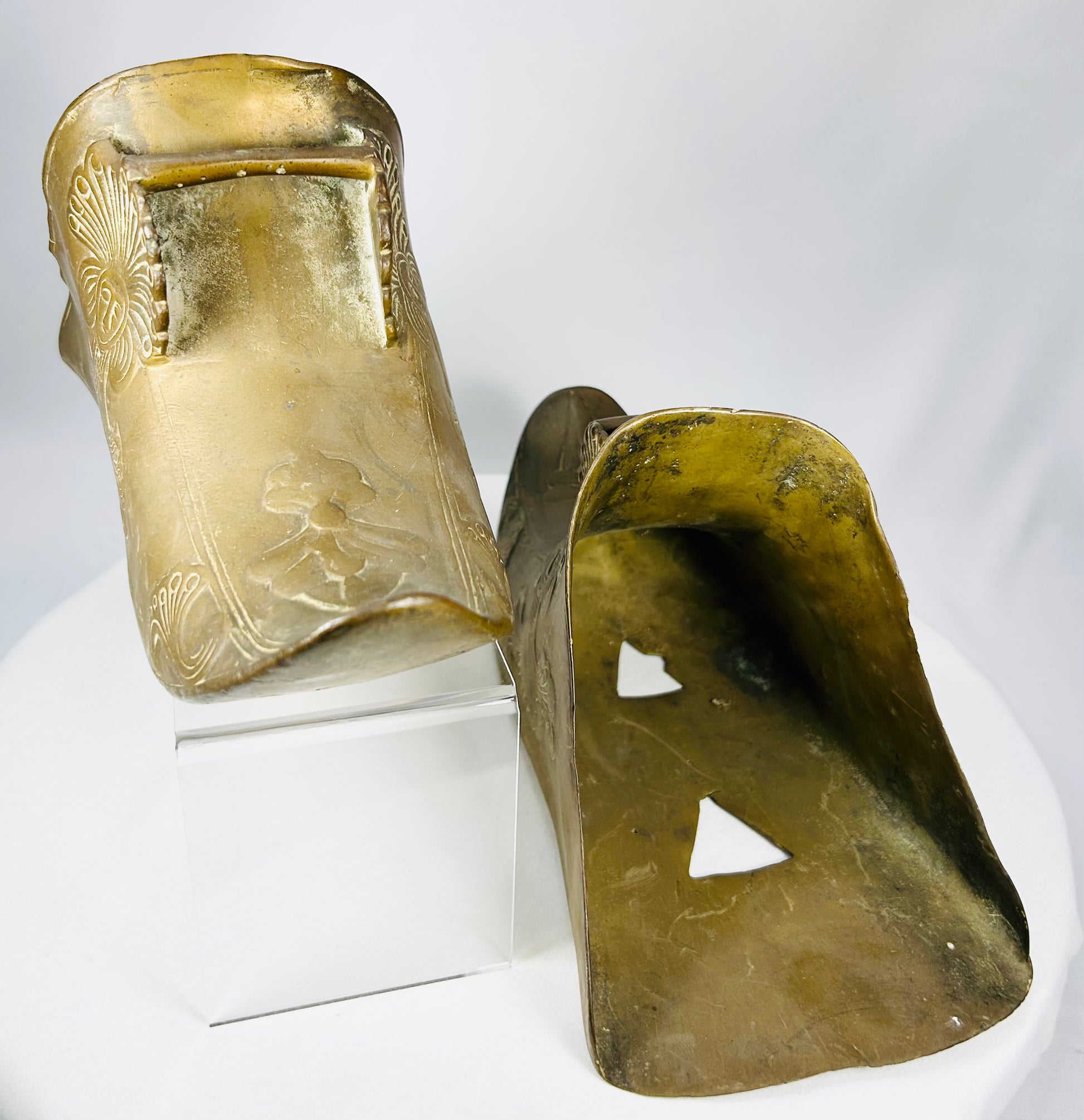 Antique Mexican or Latin American slipper stirrups with decorative Indigenous-inspired motifs.